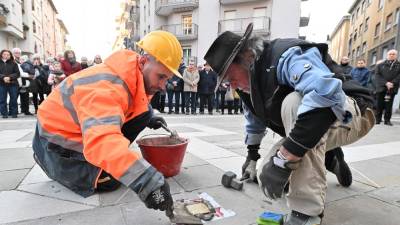 »Oče« tlakovcev Gunter Demnig (desno) med postavitvijo tlakovca v Trstu (FOTODAMJ@N)